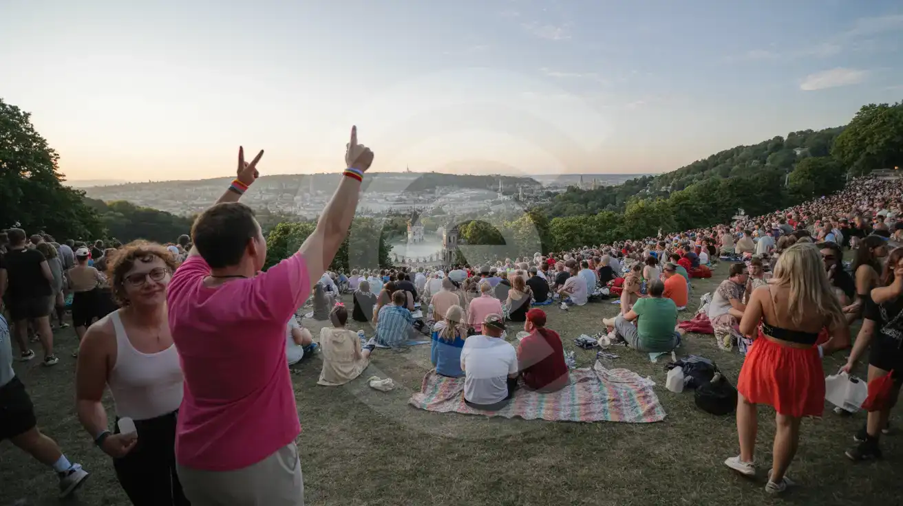 Festival crowd gathered on a hilltop park area in Prague during summer Pride week