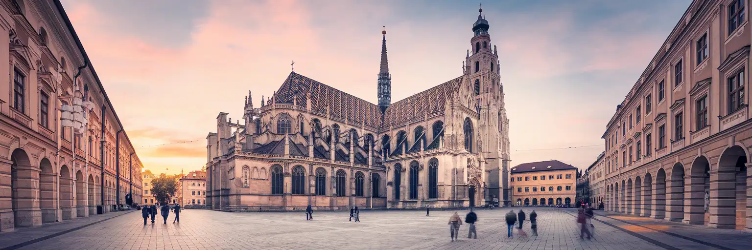 St. Stephen's Cathedral in Vienna with its Gothic spire and patterned roof at golden hour, Stephansplatz plaza in the foreground
