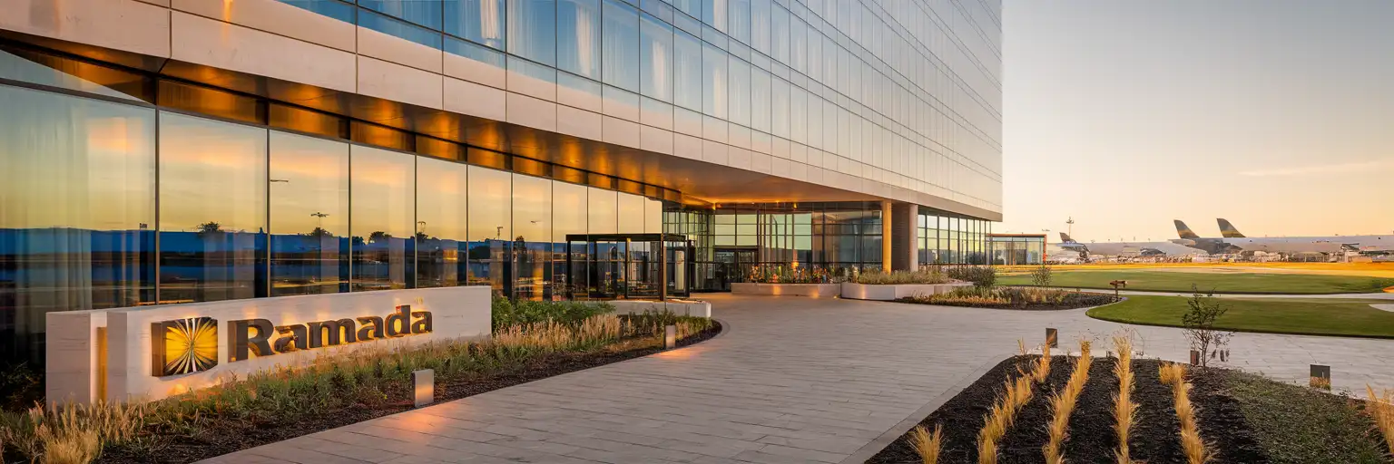 Exterior view of Ramada By Wyndham München Airport hotel near Munich Airport at golden hour