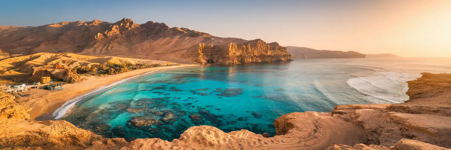 Ras Muhammad National Park coastline in Sharm El Sheikh with turquoise Red Sea waters meeting desert cliffs at golden hour