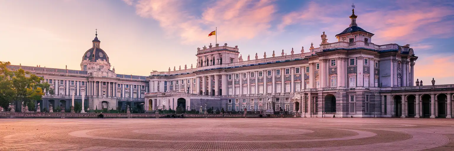 The Royal Palace of Madrid and Plaza de la Armería at golden hour with the Almudena Cathedral dome in the background