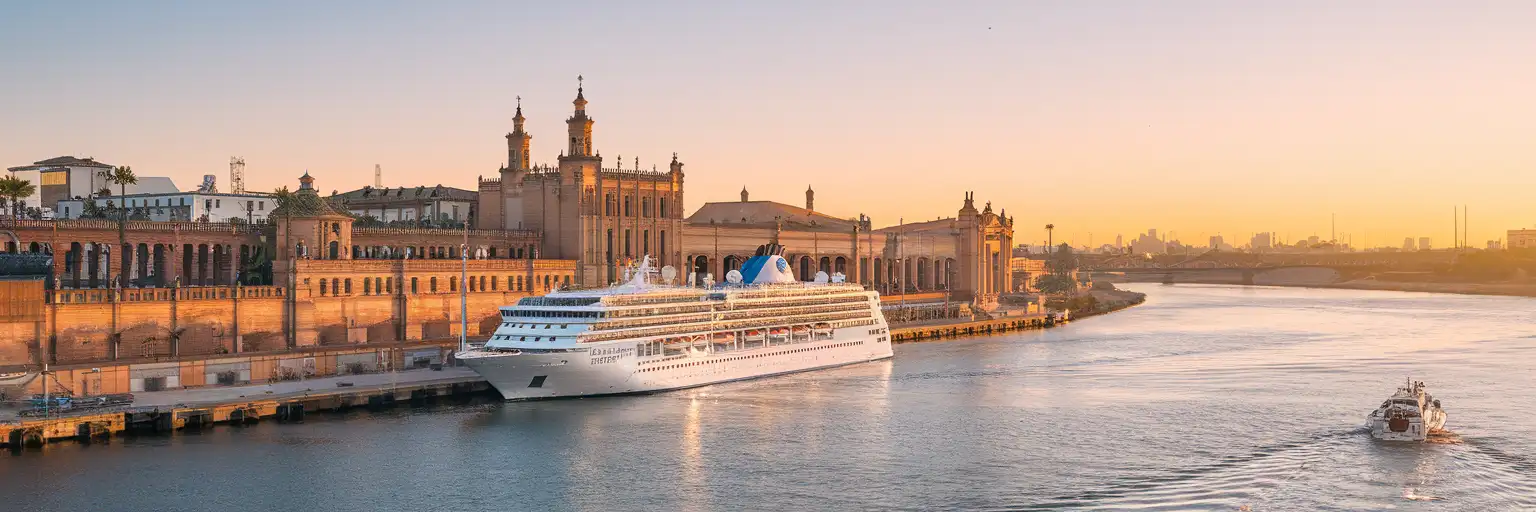 Exterior view of Port of Seville along the Guadalquivir River at golden hour