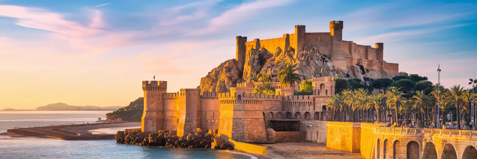 Castle of Santa Bárbara overlooking Alicante's Mediterranean waterfront at golden hour