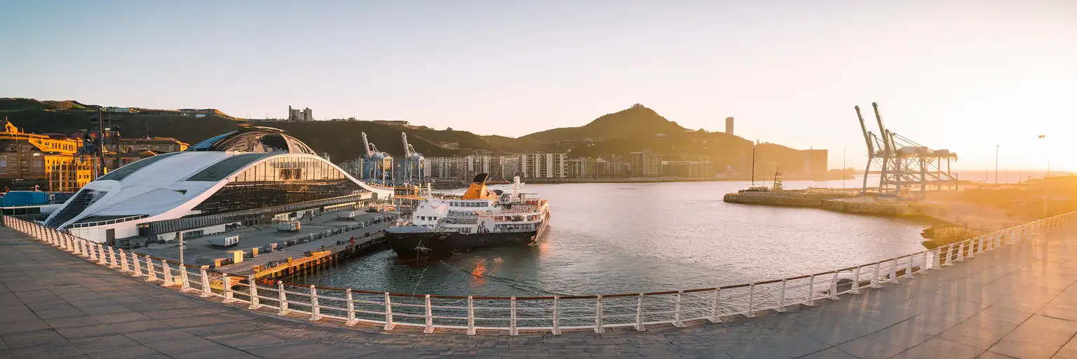 Golden-hour exterior view of Port of Bilbao cruise-port waterfront near Getxo in Bilbao, Spain
