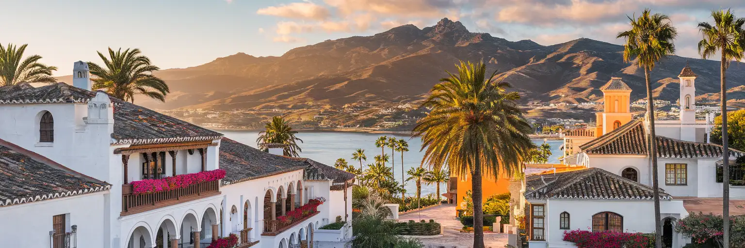 Marbella Old Town with whitewashed buildings and Sierra Blanca mountains at golden hour
