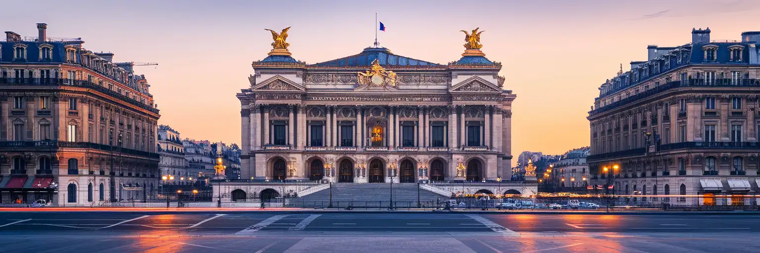 Wide exterior view of Palais Garnier in Paris at golden hour