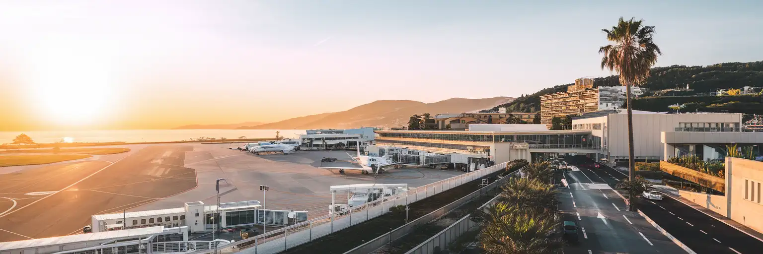 Exterior view of Cannes-Mandelieu Airport at golden hour near the Cannes coastline
