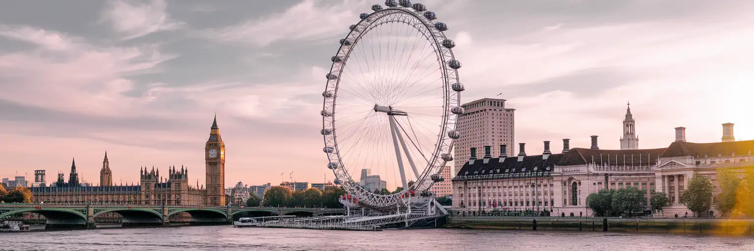 The London Eye observation wheel at golden hour with the River Thames and Westminster in the background