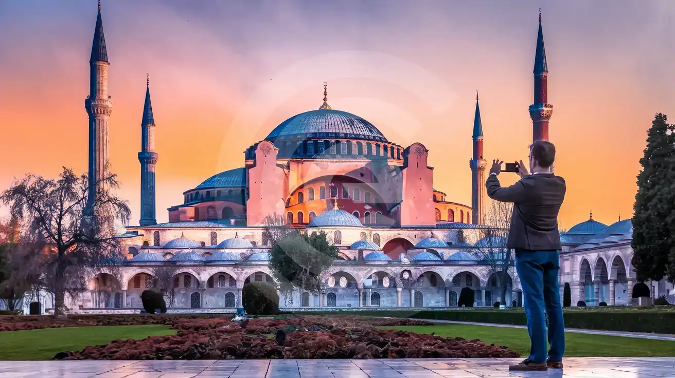 Traveler photographing Hagia Sophia from Sultanahmet Square at sunset in Istanbul