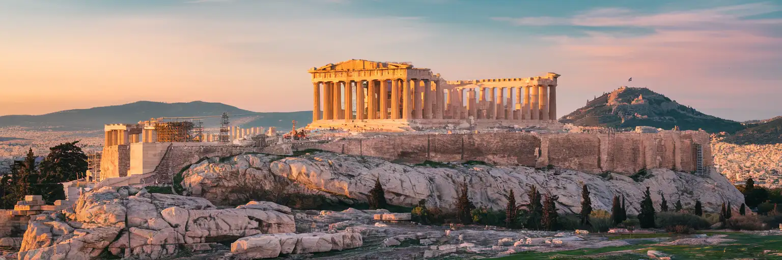 The Parthenon temple on the Acropolis of Athens glowing in golden-hour light with the city spreading below