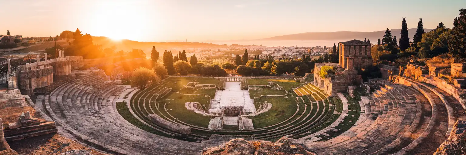 Wide exterior view of the Roman Forum of Thessaloniki archaeological site at golden hour in central Thessaloniki