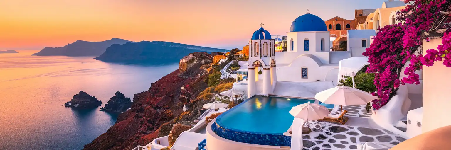 Vedema Resort Santorini whitewashed Cycladic architecture overlooking the caldera at golden hour