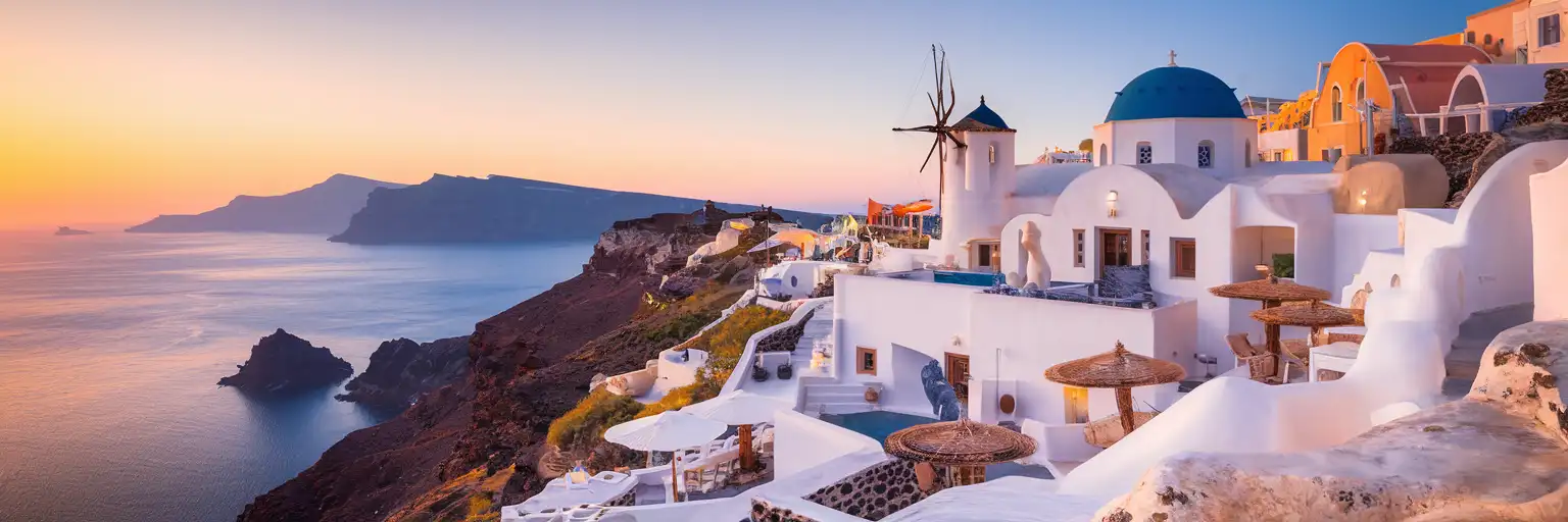 Whitewashed exterior of Art Space Santorini gallery and winery carved into volcanic rock in Exo Gonia village at golden hour