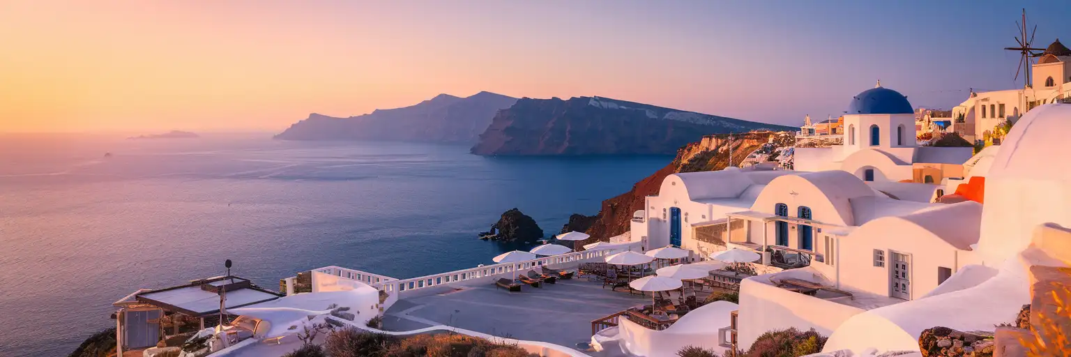 Santorini (Thira) National Airport terminal building with the Aegean Sea and volcanic caldera cliffs in the background at golden hour