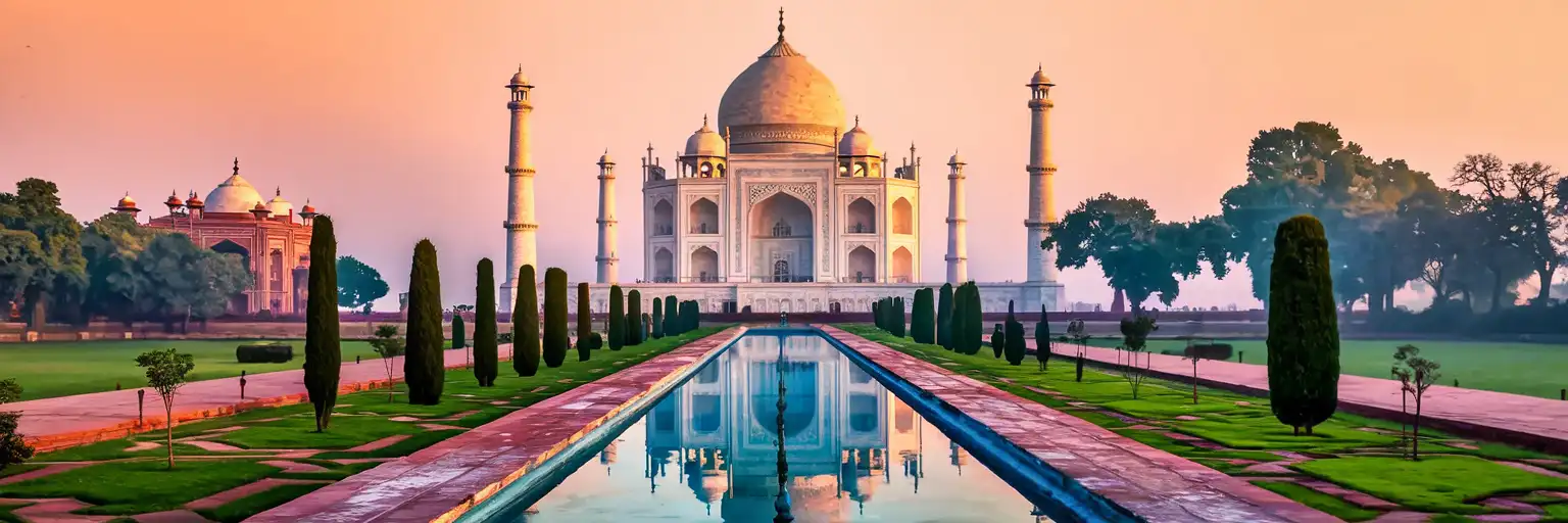 The Taj Mahal in Agra at golden hour with its reflection in the long pool and manicured gardens