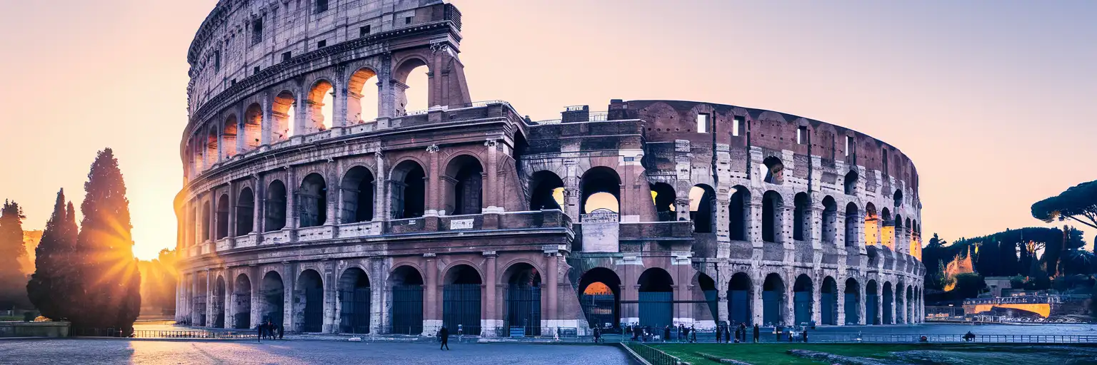 Golden-hour exterior view of the Colosseum in Rome showing the four-storey travertine arches and the Arch of Constantine