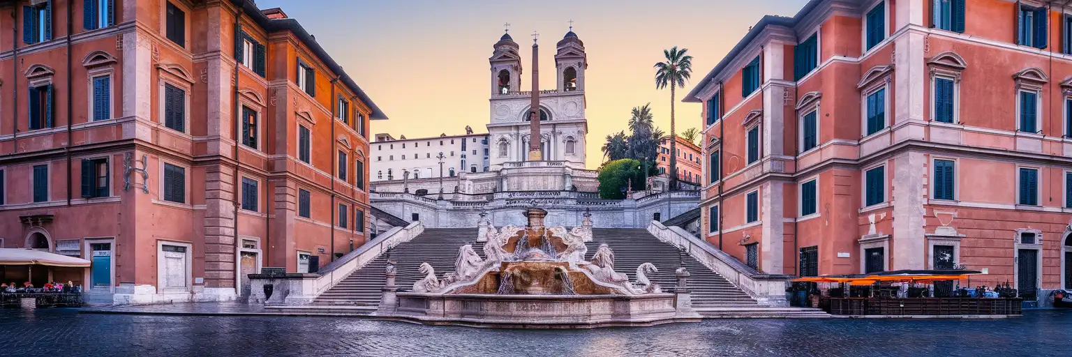 The Spanish Steps monumental staircase rising from Piazza di Spagna to the Trinità dei Monti church at golden hour in Rome
