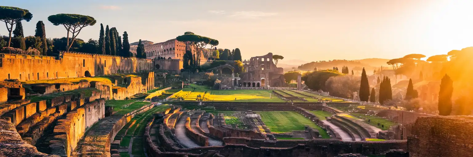 Wide golden-hour view from Palatine Hill over ancient ruins toward the Colosseum in Rome, Italy