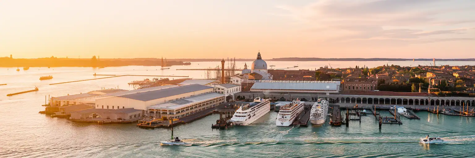 Wide exterior view of Port of Venice cruise terminal area at sunset in Venice, Italy
