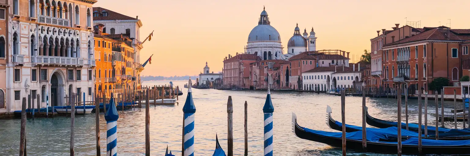 Basilica di Santa Maria della Salute at golden hour with gondola poles and Grand Canal reflections in Venice, Italy