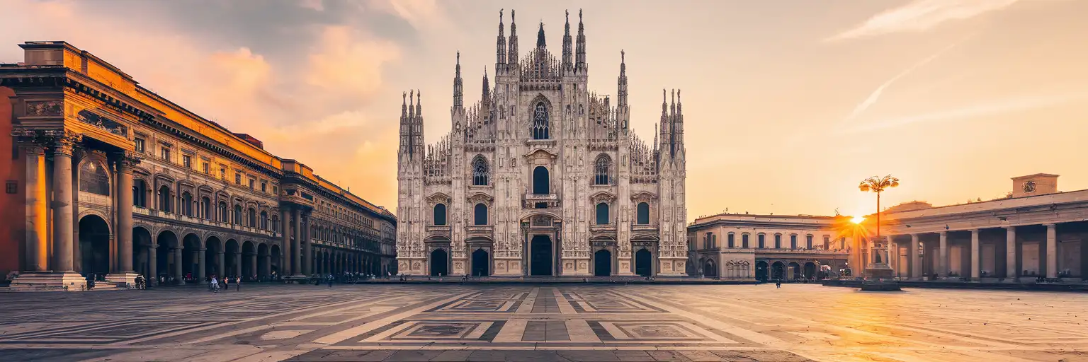 The Gothic spires of Milan's Duomo di Milano cathedral rising above Piazza del Duomo at golden hour