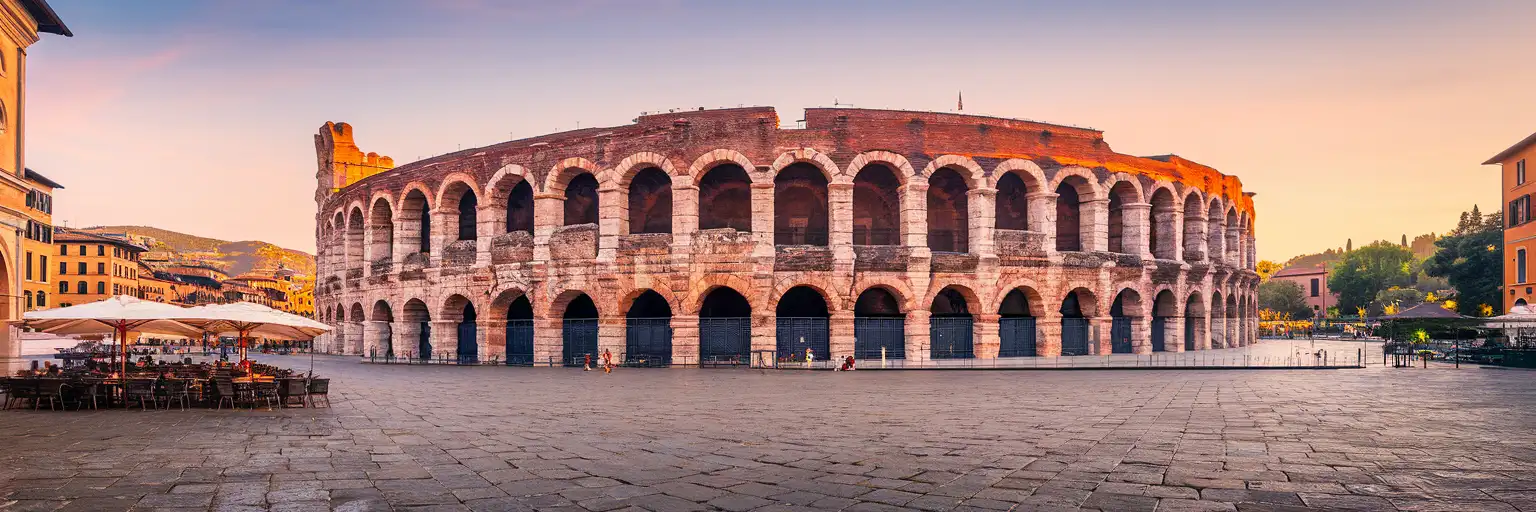 Arena di Verona Roman amphitheater at golden hour with Piazza Bra and historic Verona rooftops in the background