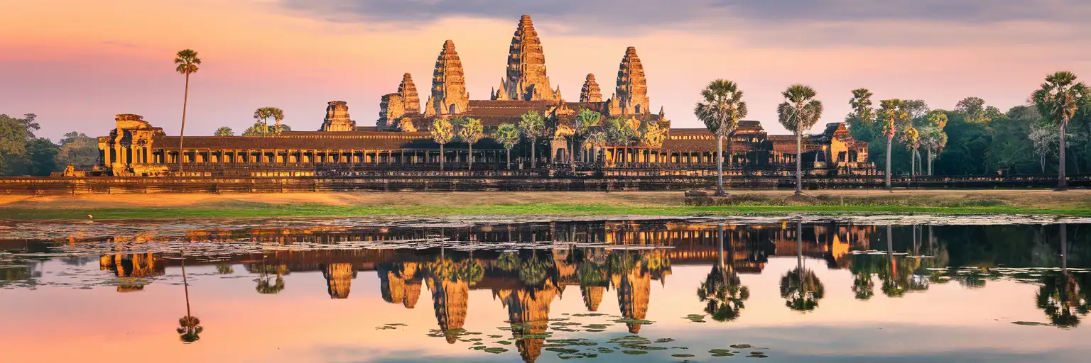 Angkor Wat temple towers reflected in the moat at golden hour in Siem Reap, Cambodia