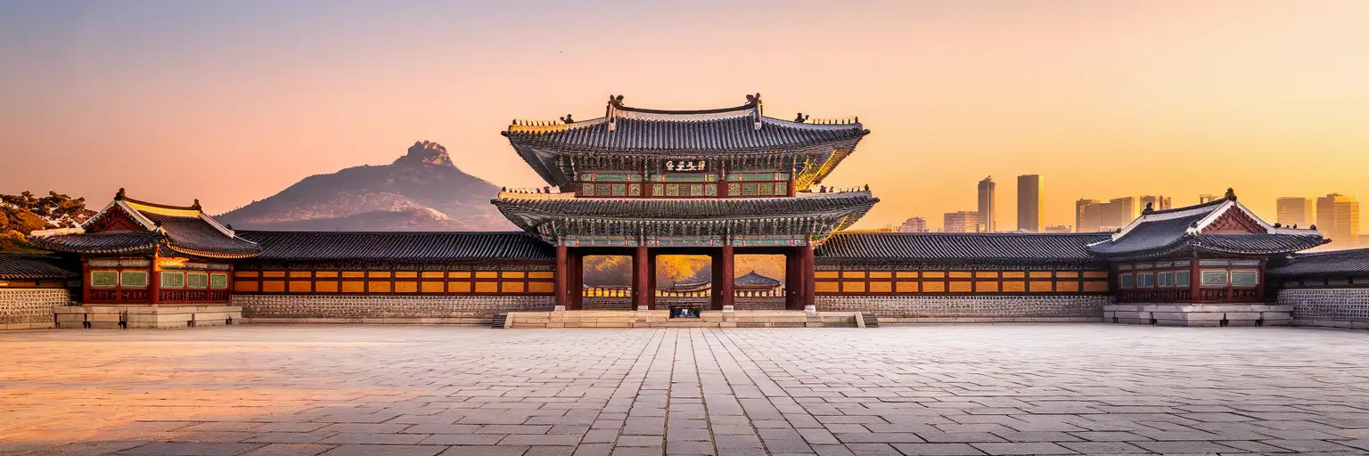 Gyeongbokgung Palace throne hall with Bukhansan mountain and Seoul skyline at golden hour