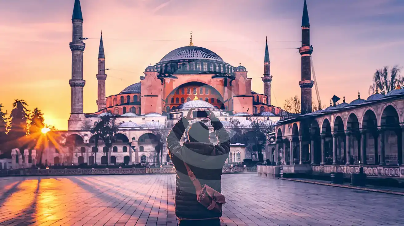 Traveler photographing Hagia Sophia at golden hour from Sultanahmet Square in Istanbul