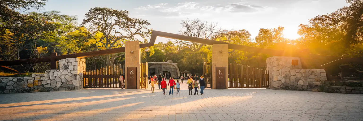 Wide exterior view of Chapultepec Zoo entrance in Mexico City at golden hour