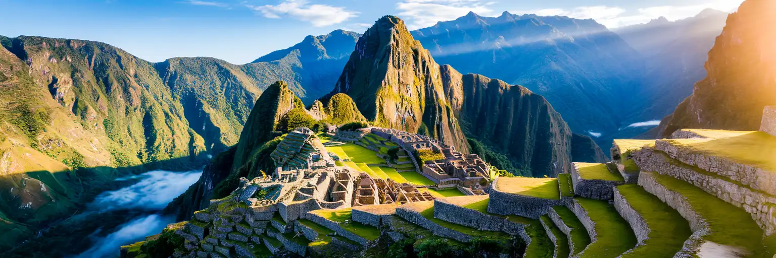Machu Picchu ancient Incan citadel on a mountain ridge in Peru's Andes at golden hour with Huayna Picchu peak behind