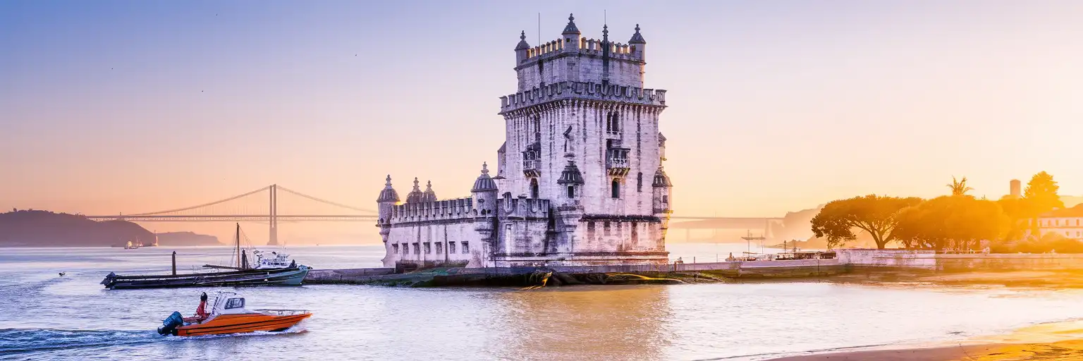 Belém Tower on the Tagus River waterfront in Lisbon at golden hour with the 25 de Abril Bridge in the background