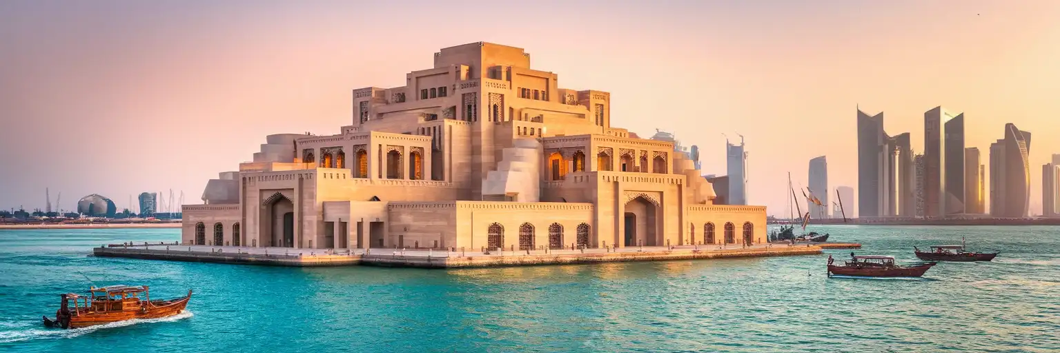 The Museum of Islamic Art rising from Doha Bay at golden hour with the Qatar skyline in the background