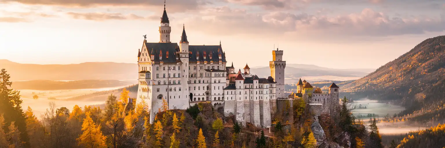 Bran Castle rising from forested Carpathian hills in Transylvania, Romania at golden hour