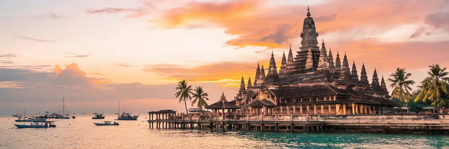 The Sanctuary of Truth wooden temple rising from Pattaya's shoreline at golden hour with the Gulf of Thailand beyond