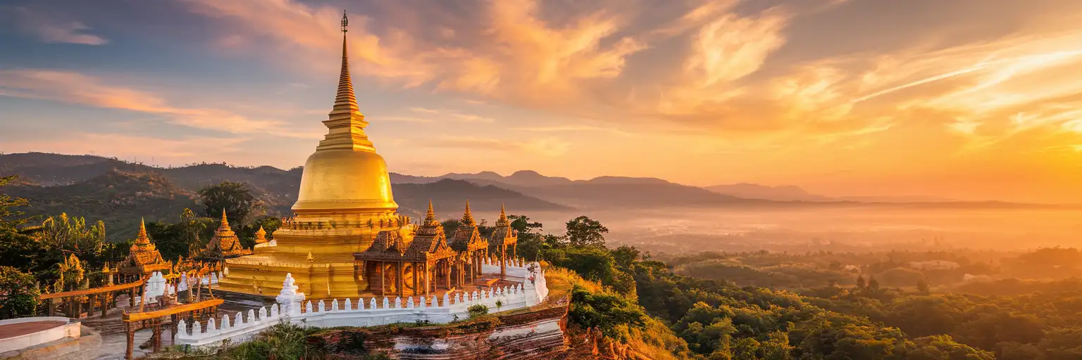 Golden spire of Wat Phra That Doi Suthep temple overlooking Chiang Mai valley at sunset