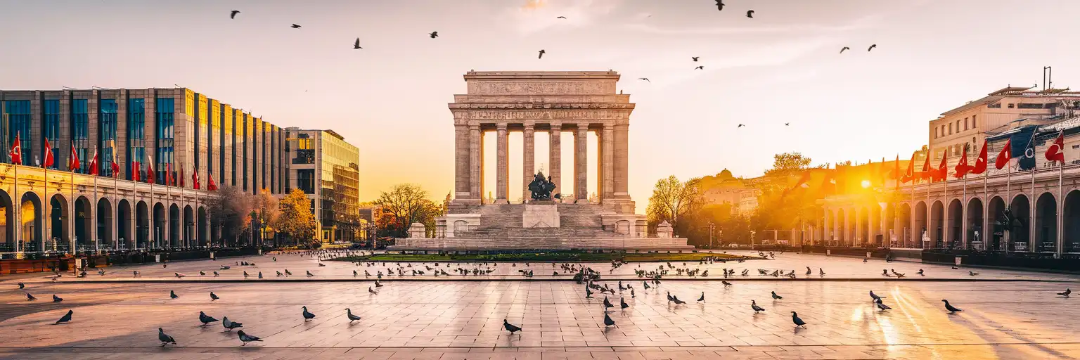 Republic Monument in Taksim Square at golden hour with the Atatürk Cultural Center and İstiklal Caddesi entrance visible across the plaza