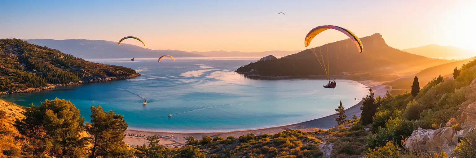 Ölüdeniz Blue Lagoon at golden hour with turquoise waters, white pebble beach, and Babadağ mountain in Fethiye, Turkey