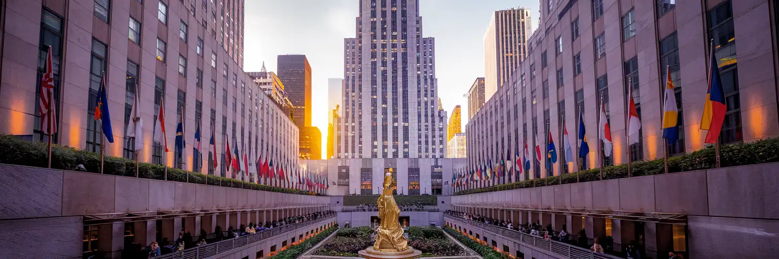 Golden hour view of 30 Rockefeller Plaza tower and the Channel Gardens with the Prometheus statue in the Lower Plaza
