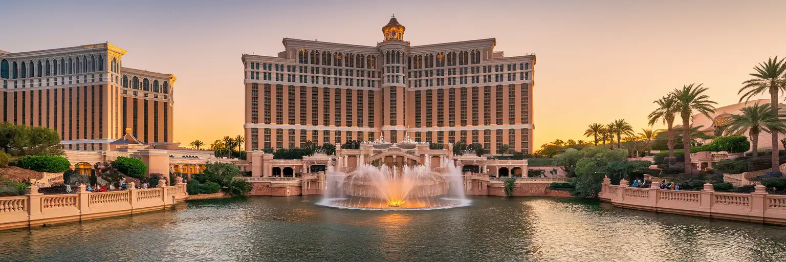 Exterior view of Bellagio on the Las Vegas Strip with the Bellagio lake and fountains at sunset