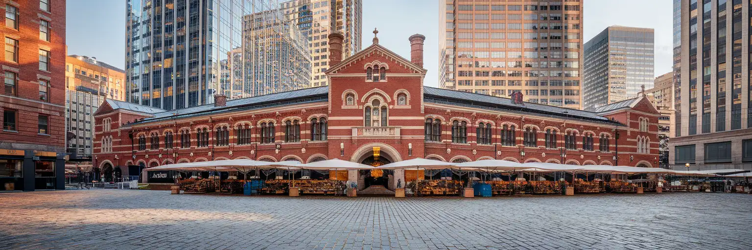 Faneuil Hall and Quincy Market with downtown Boston skyline at golden hour